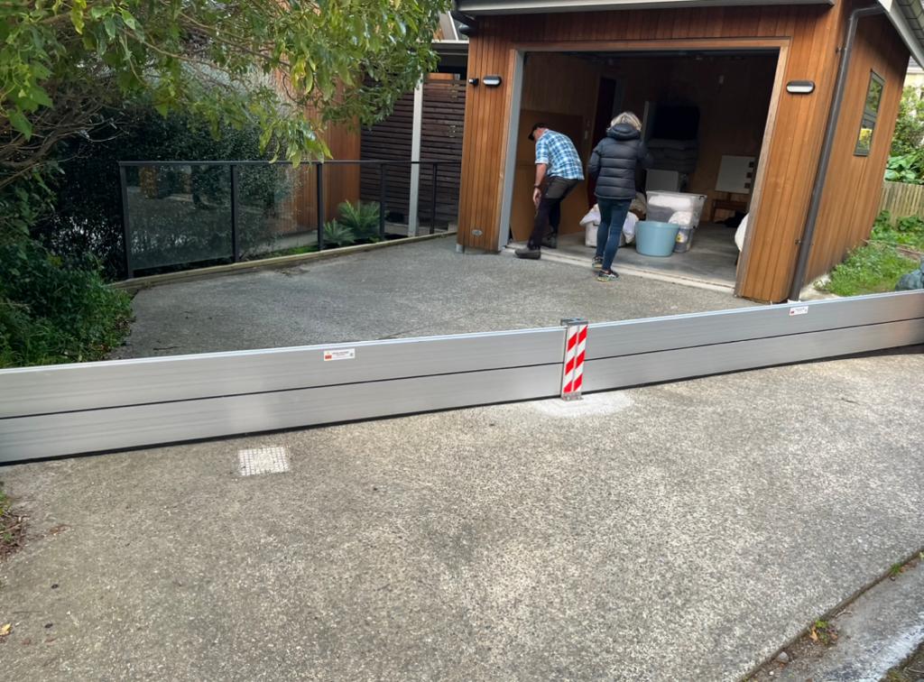 Aluminium barrier across a sloping driveway entrance