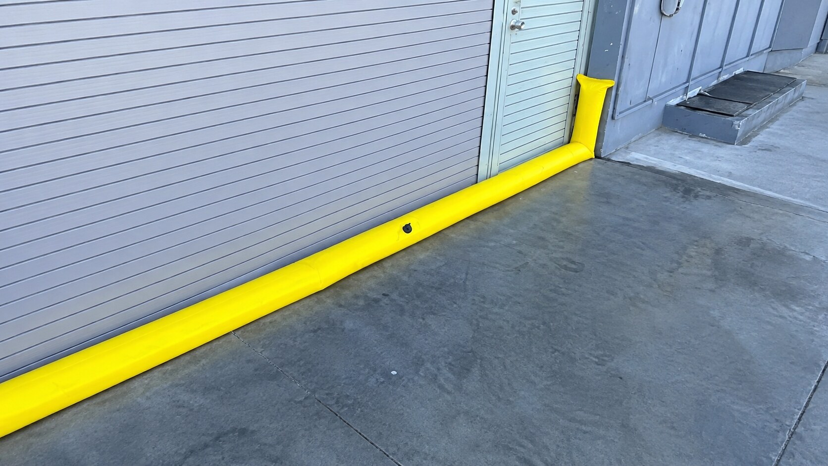 Yellow FloodLine Series Pro barrier protecting a garage entrance