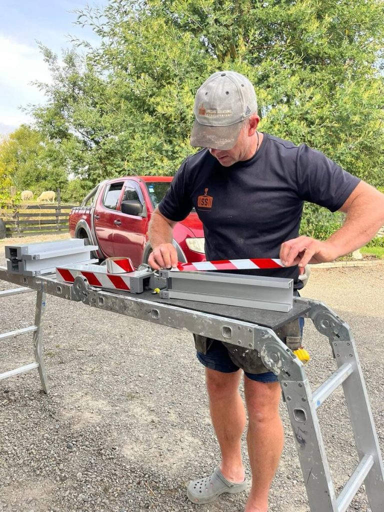 Applying high-visibility markings to a removable aluminium flood barrier component