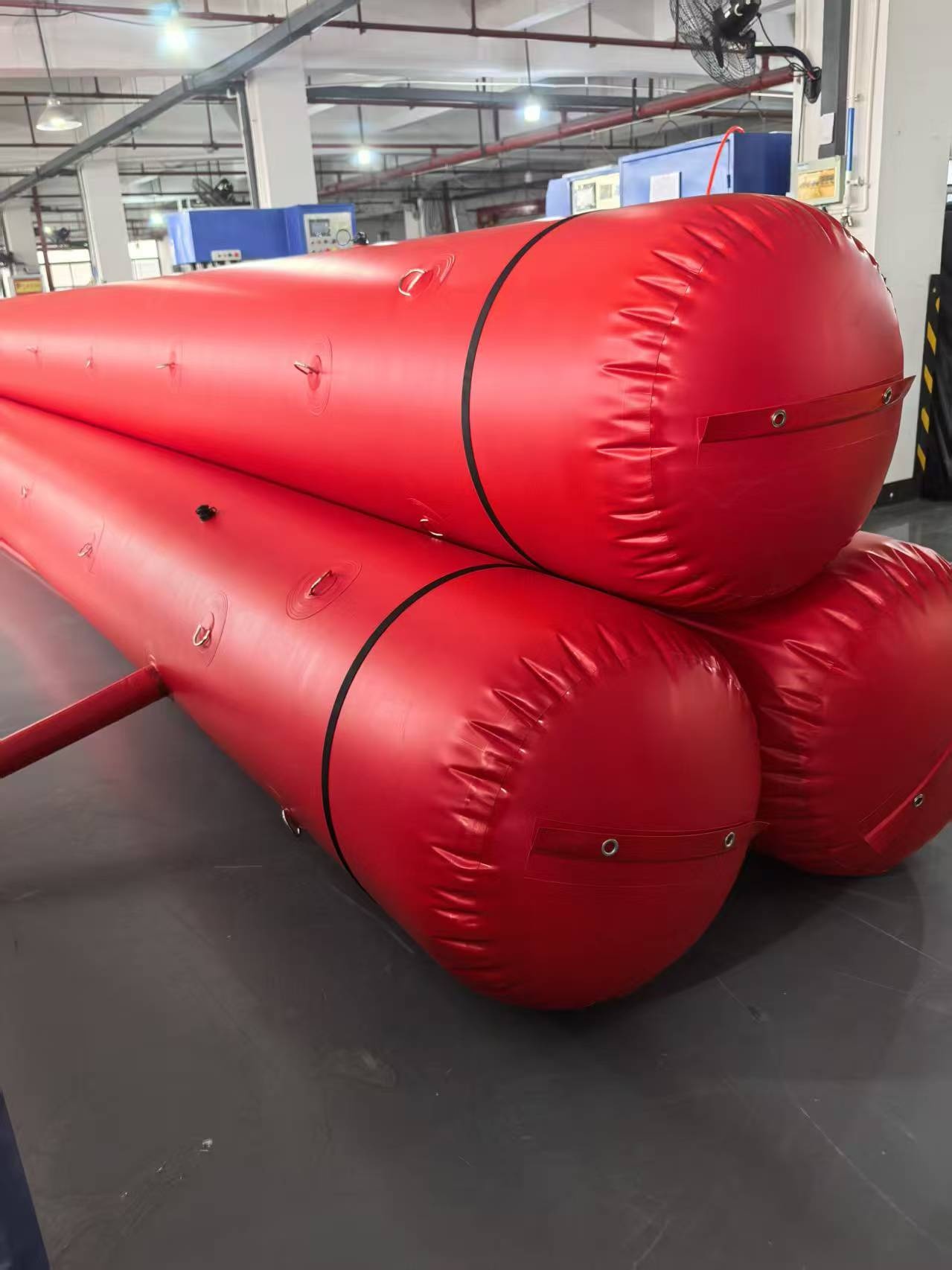 Red FloodLine XL triple-pipe water-filled flood barrier assembled indoors