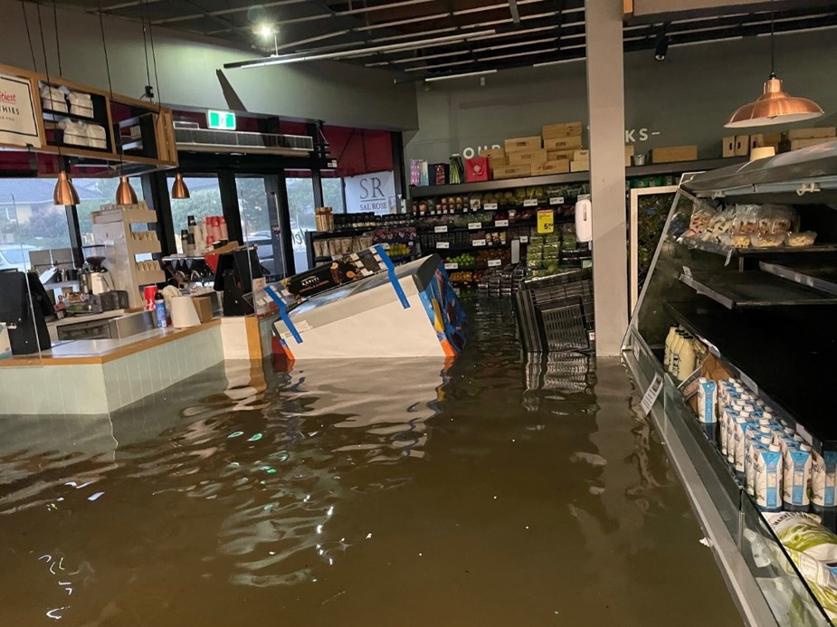 Deep floodwater surrounding shelves and equipment inside Fresh Collective Alberton in January 2023