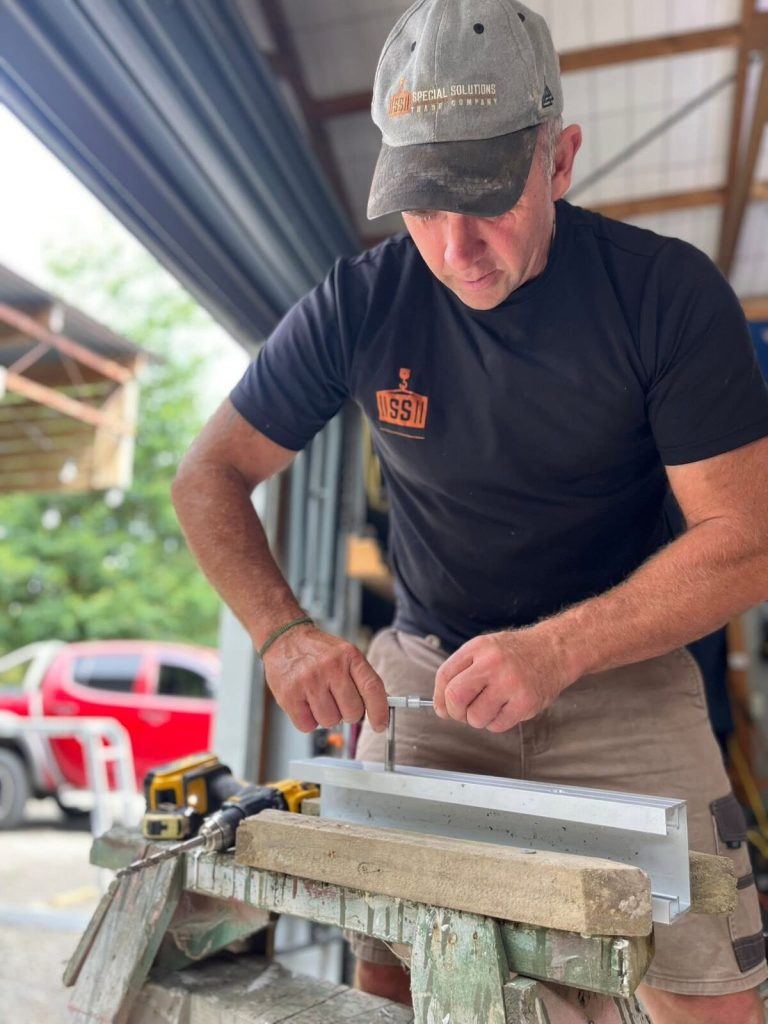 Allan McLean preparing a custom FloodShield aluminium barrier for a South Island homeowner