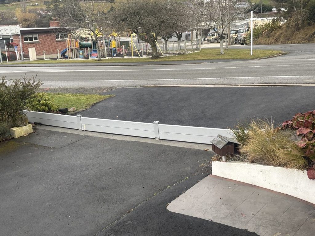 Removable aluminium FloodShield barrier installed across a South Island home driveway